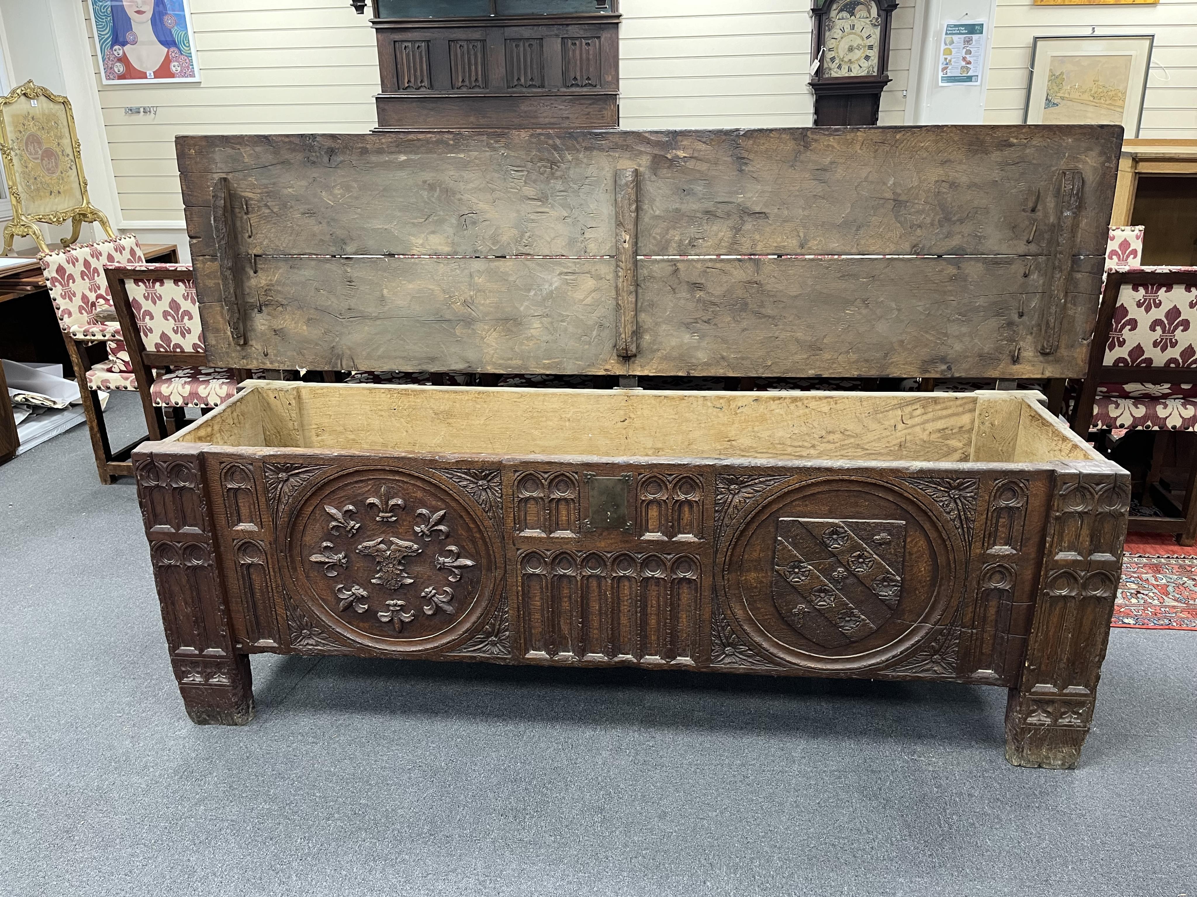 A large and impressive heraldic boarded oak coffer, in 16th century Tudor style, carved with armorial roundels, width 243cm, depth 65cm, height 78cm. Condition - fair, Provenance - made for Brede Place, Brede, Rye, East